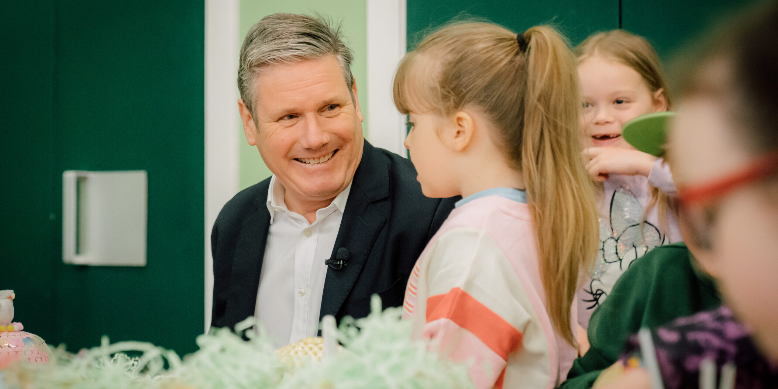 Keir Starmer sat at a table with a child