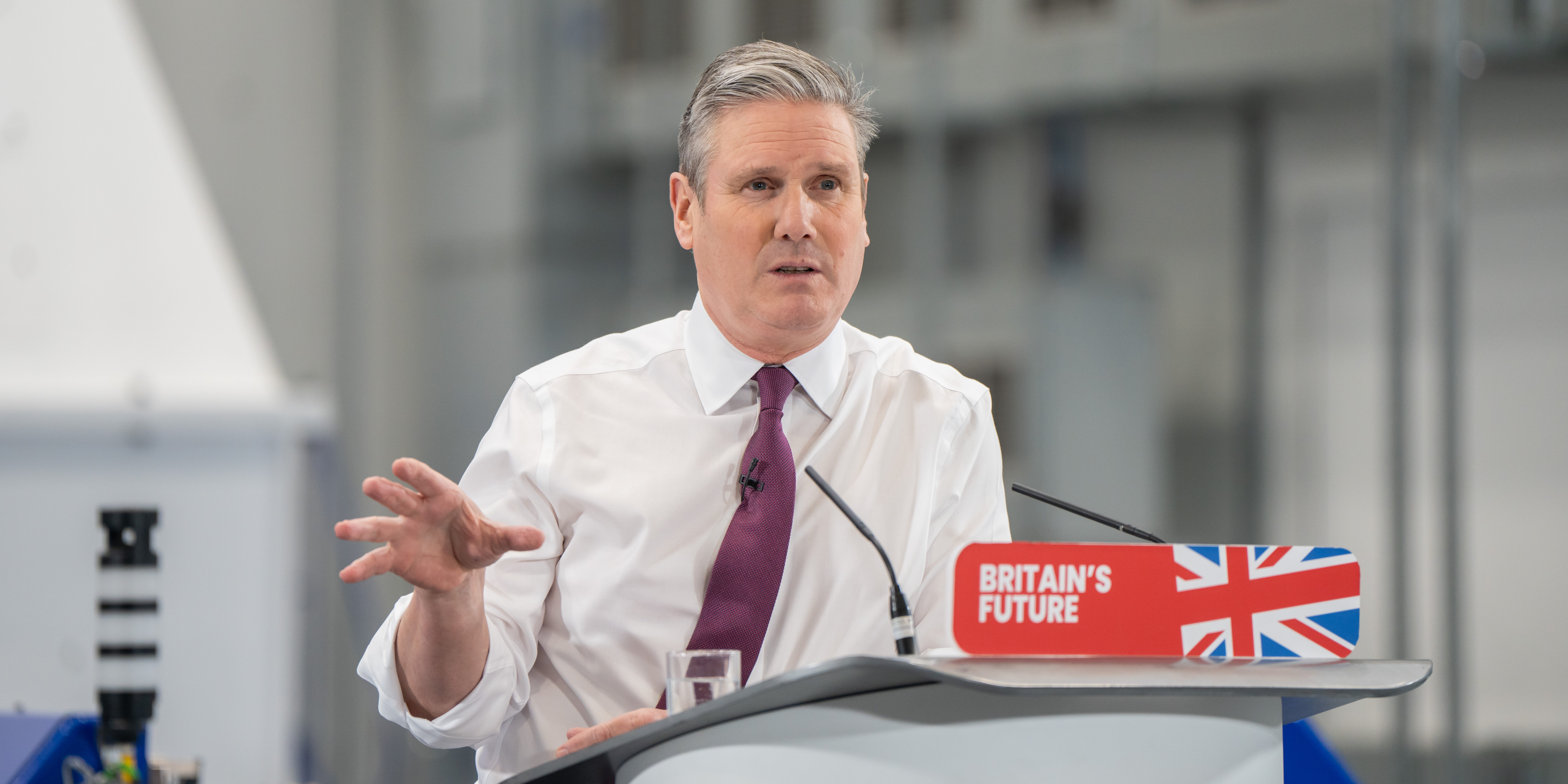 Keir Starmer delivering a speech in Bristol behind a lectern reading 'Britain's Future'