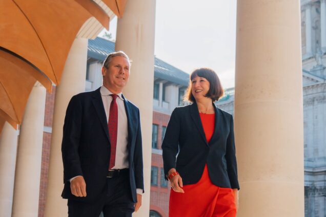 Keir Starmer and Rachel Reeves walking past pillar outside London Stock Exchange
