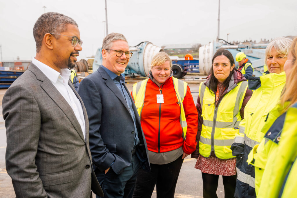Keir Starmer and Vaughan Gething talk to a group of women in the Port of Holyhead, in North Wales