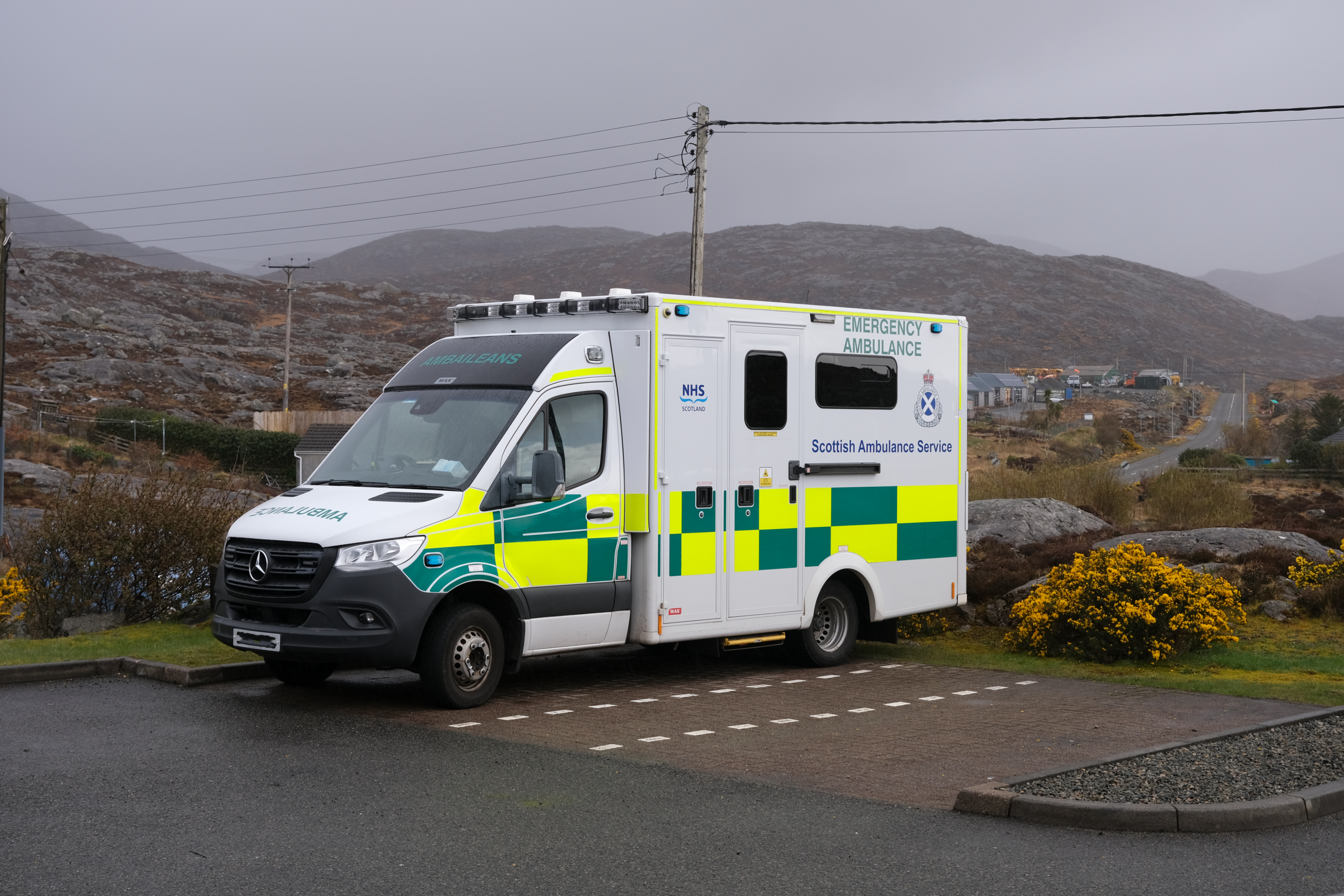 View of a parked Scottish ambulance beside a rural road