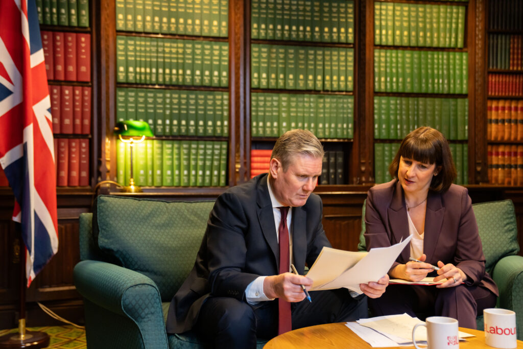 Keir Starmer and Keir Starmer seated side by side, looking at a document, as they prepare for the Budget.