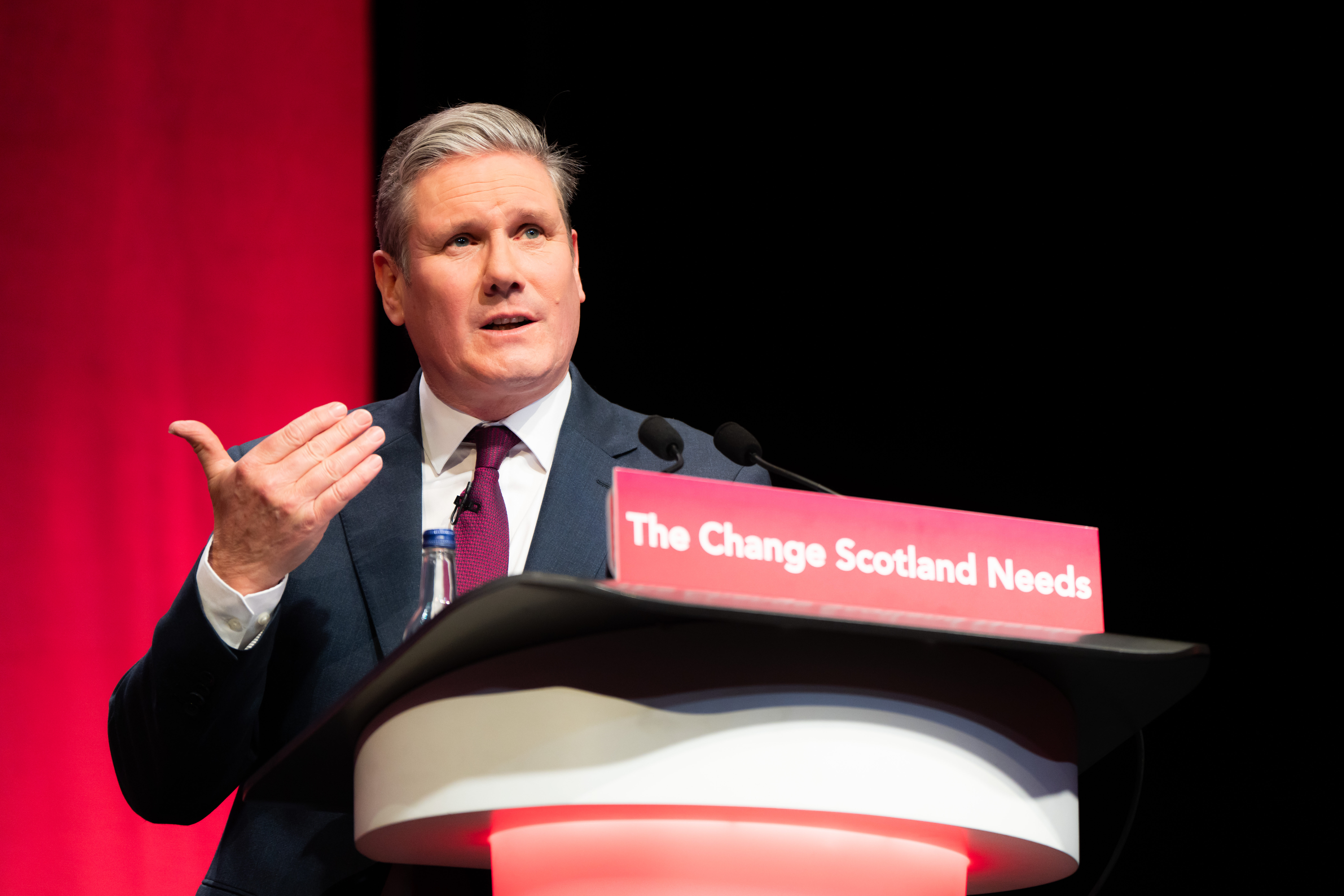 Keir Starmer speaking at a podium at the Scottish Labour conference