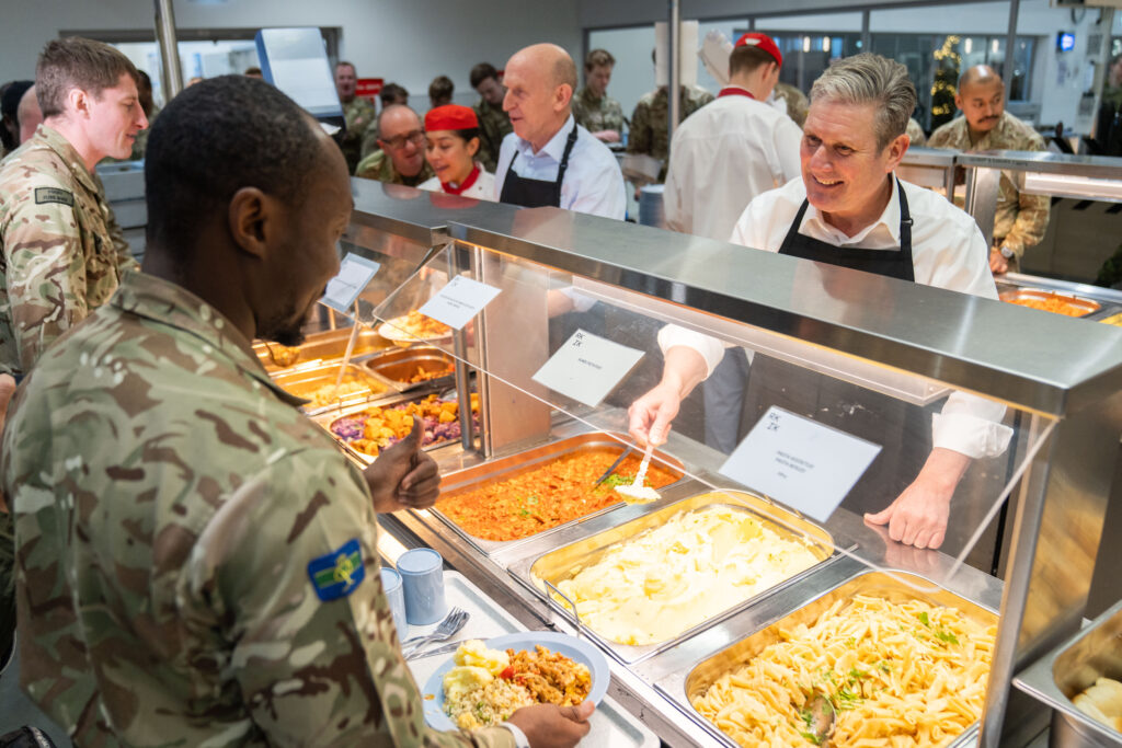 Keir Starmer and John Healey, Shadow Defence Secretary, serving lunch to members of the British armed forces deployed to Estonia.