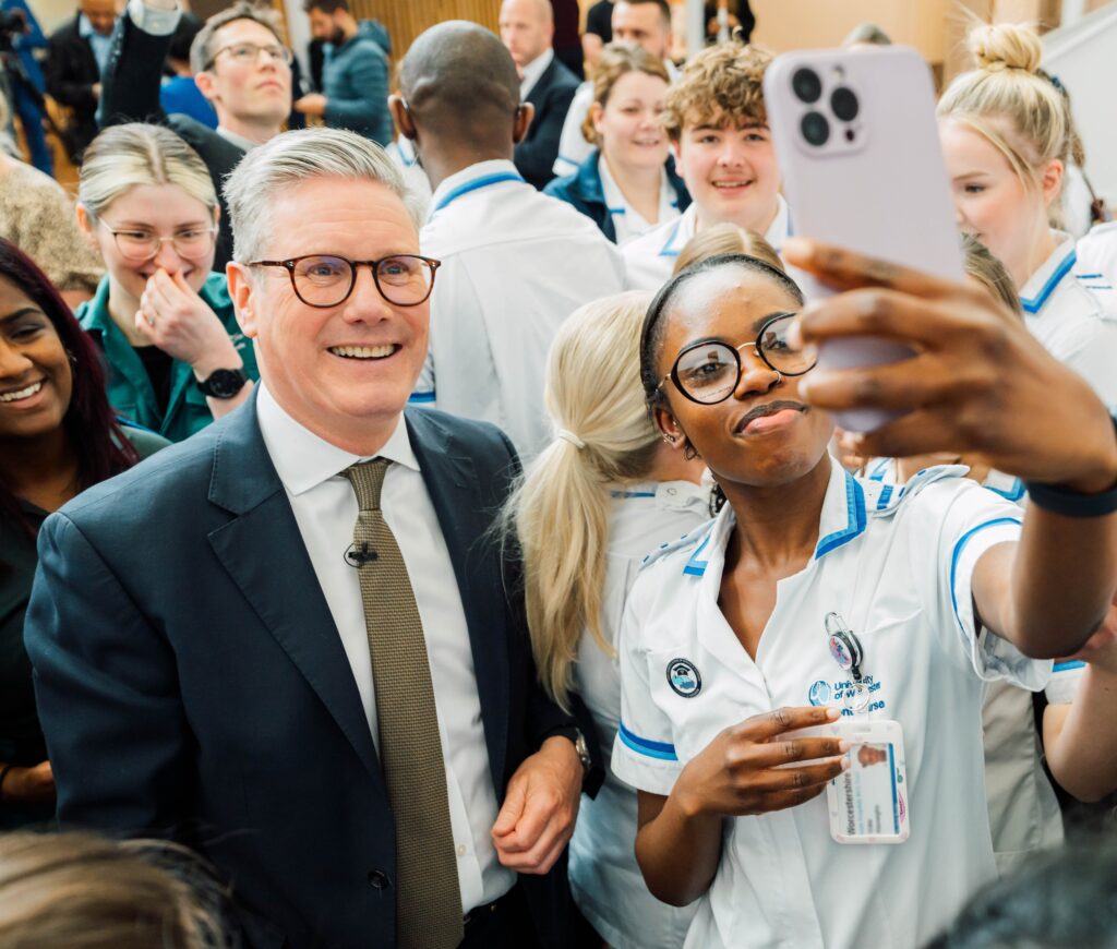 Keir Starming posing for a selfie with a female medical student.