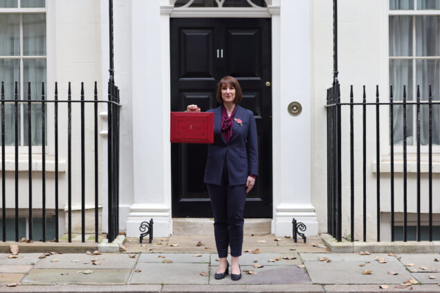 Rachel Reeves holding up a ministerial red box outside 11 Downing Street