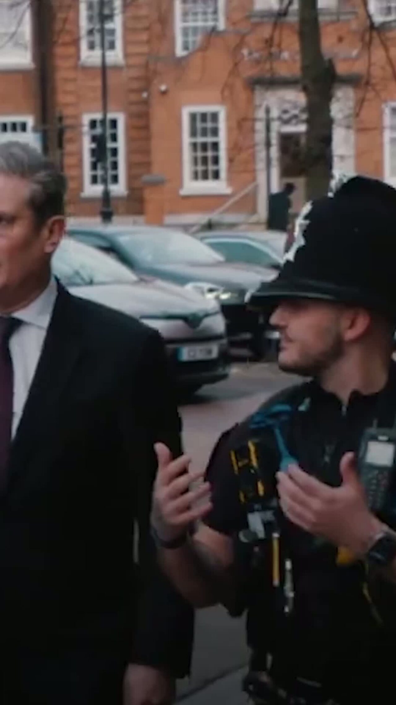 Prime Minister Keir Starmer talking to a police officer.