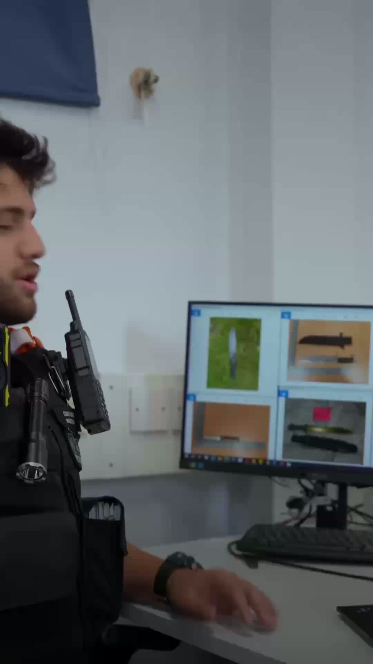 A photo of a police officer showing the knives they have confiscated