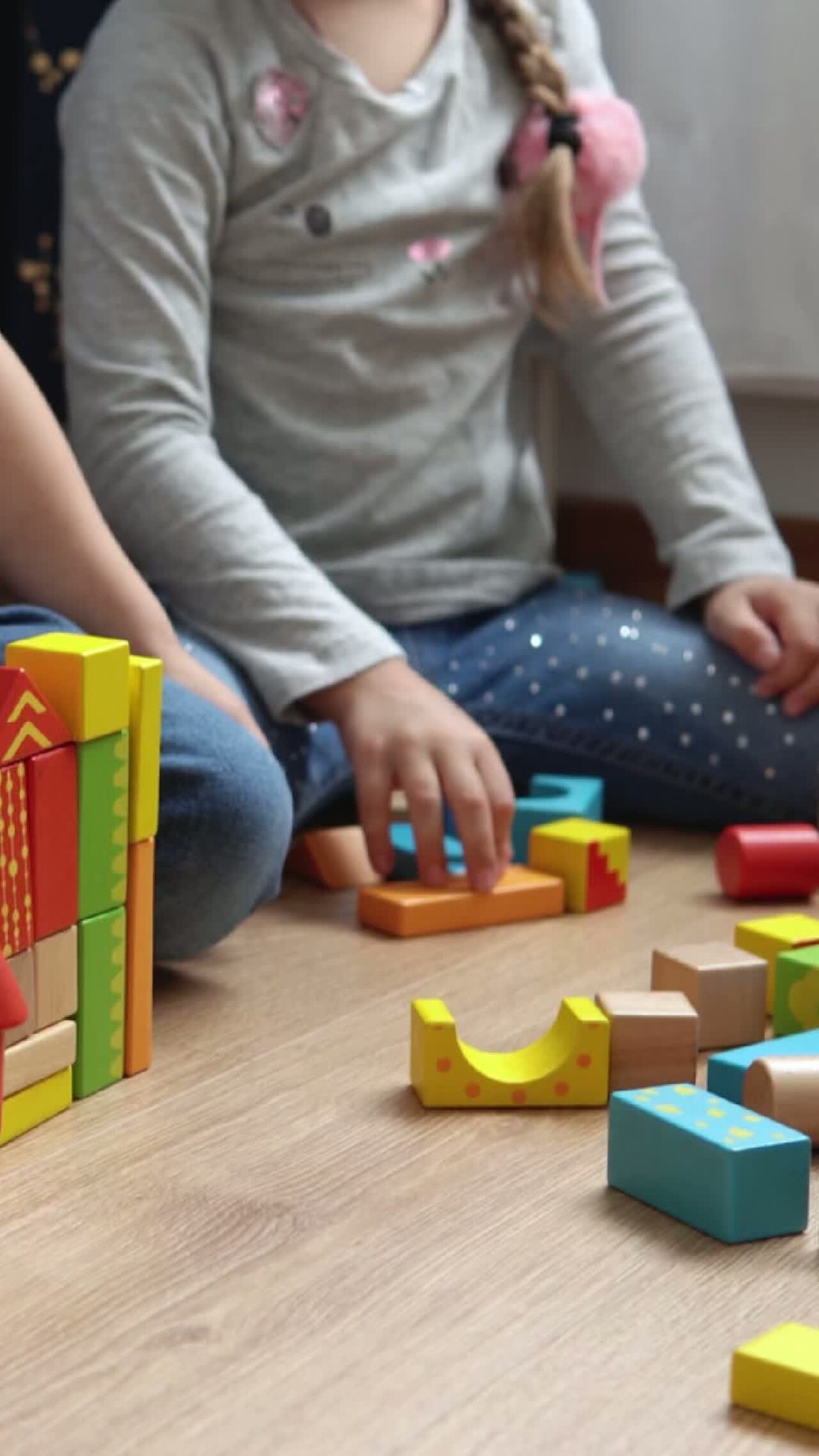 A photo of a child playing with some building blocks.