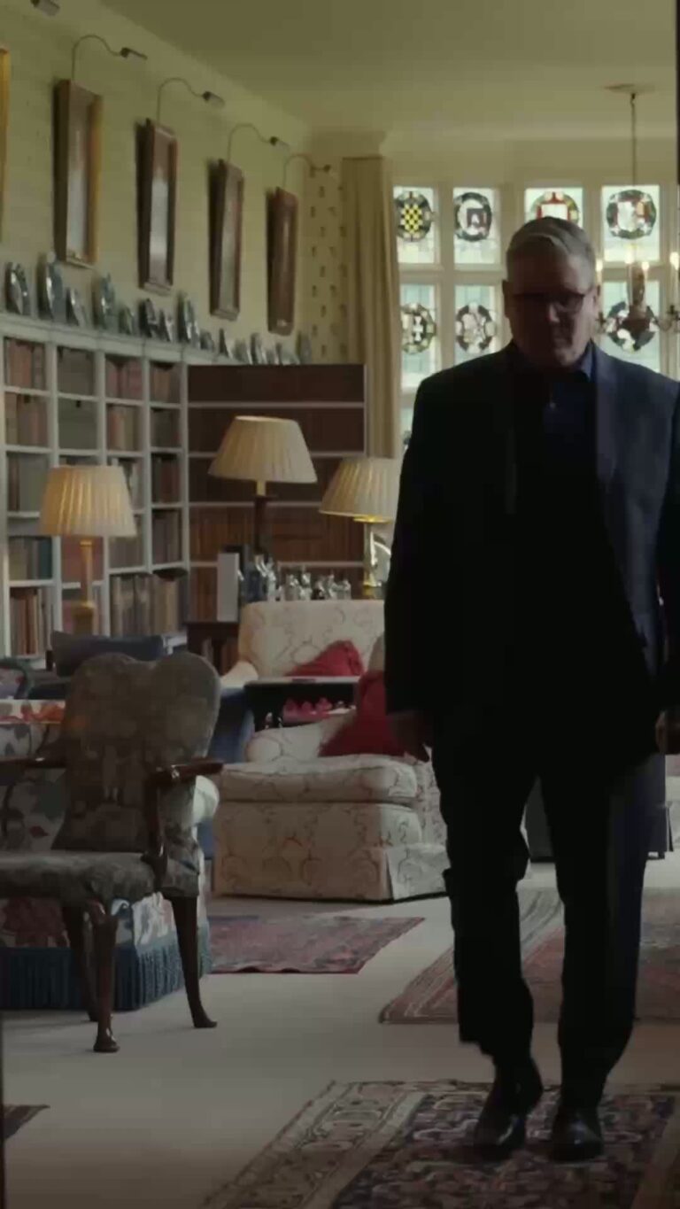 Prime Minister Keir Starmer walking through a room